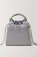 Side angle of EACHY grey drawstring cooler bag showing pockets