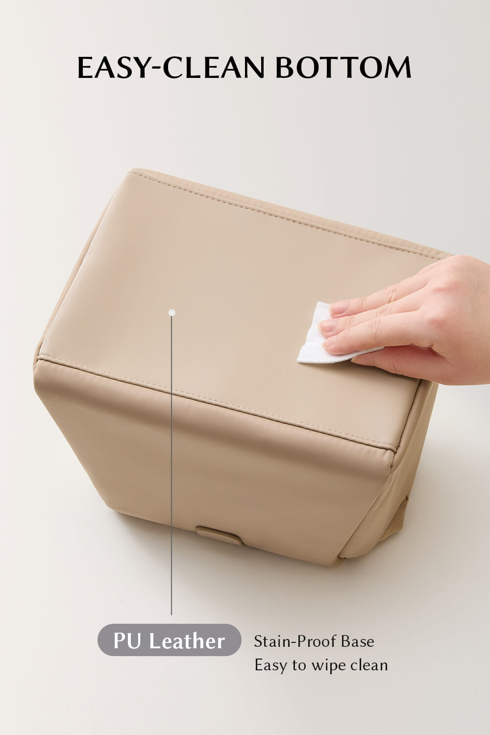 Hand wiping the durable bottom of EACHY beige lunch bag