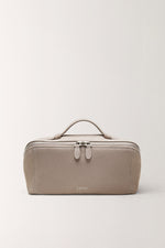Minimalist taupe gray toiletry bag for travel essentials front view