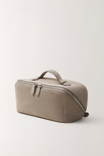 Portable gray travel makeup bag with handle and zipper side view