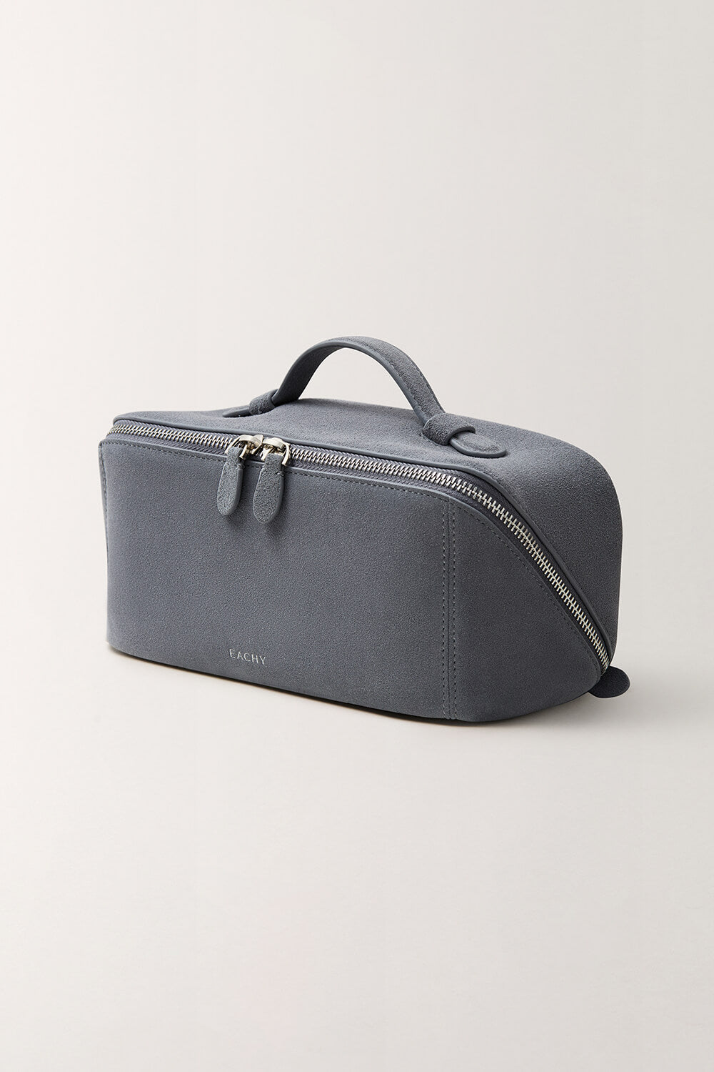 Slate blue cosmetic bag side view, minimalist design with durable handle and double zippers