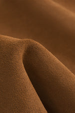 Close-up texture shot of premium soft suede-like brown fabric, durable material detail