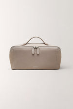 Minimalist taupe gray toiletry bag for travel essentials front view