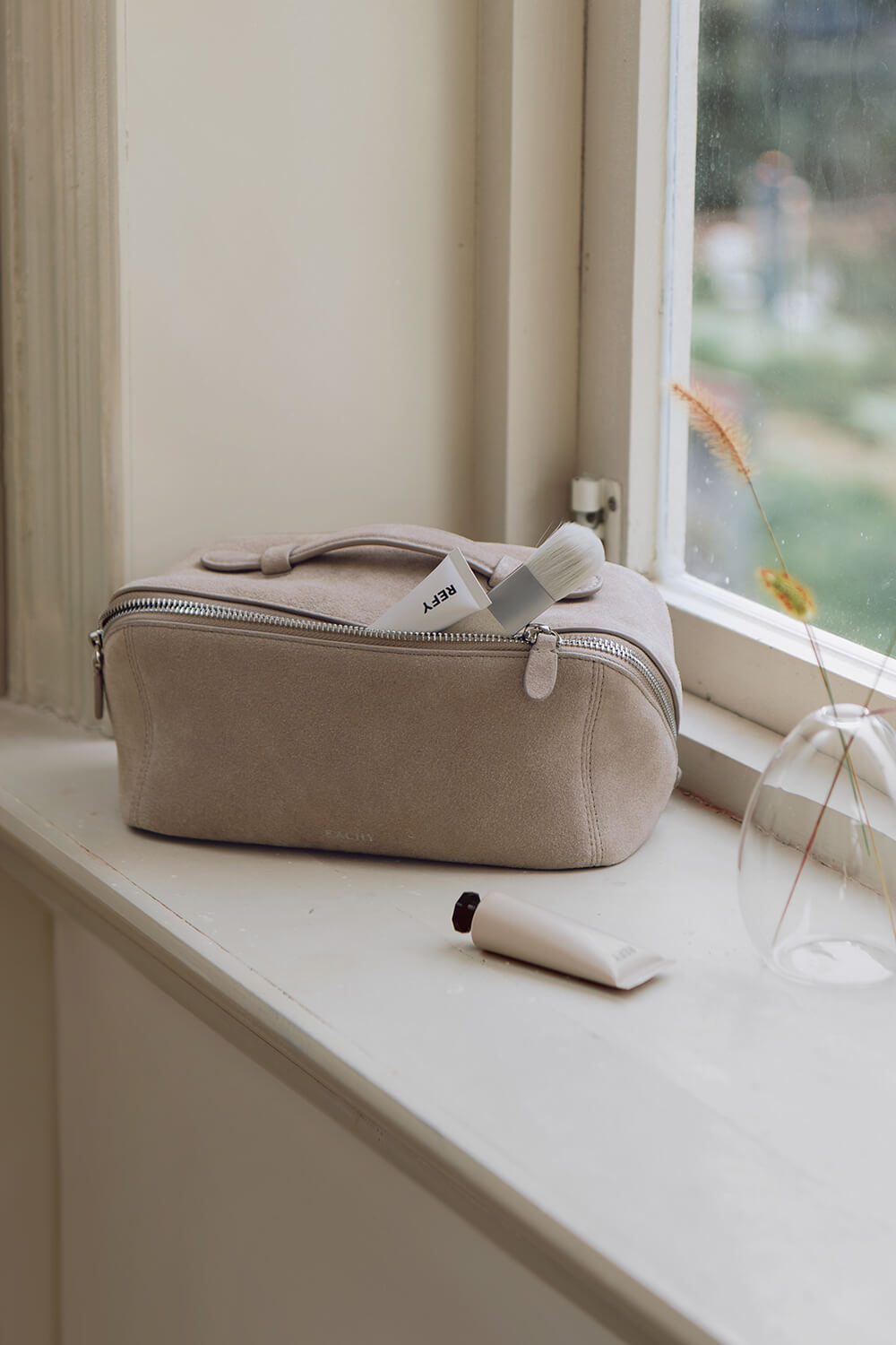 Aesthetic gray makeup organizer sitting on window sill for home decor
