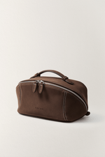 Side view of black vegan leather makeup bag, portable travel toiletry bag pouch.