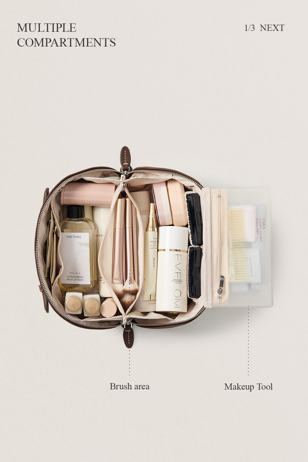 Open black makeup bag flatlay showing skincare storage, organized travel cosmetic bag.