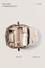 Open black makeup bag flatlay showing skincare storage, organized travel cosmetic bag.