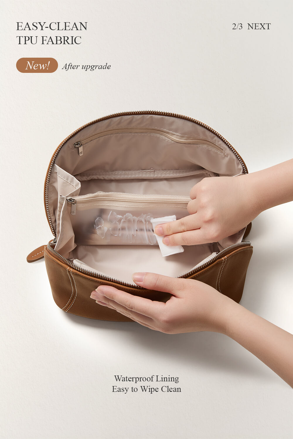 Hands demonstrating interior pockets of black makeup bag, partitioned travel toiletry bag.