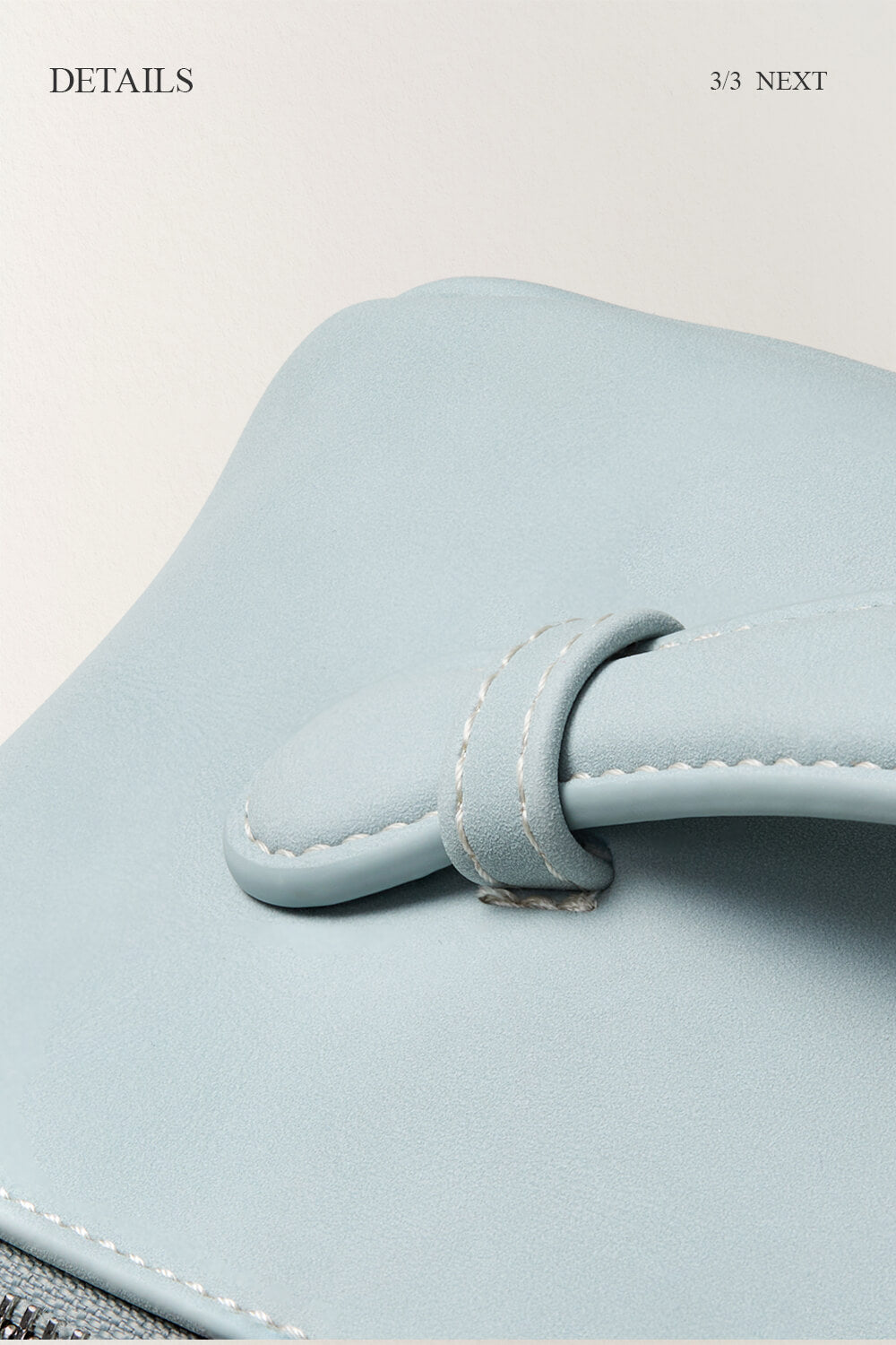 Detail shot of blue makeup bag zipper and handle, high quality travel cosmetic bag.