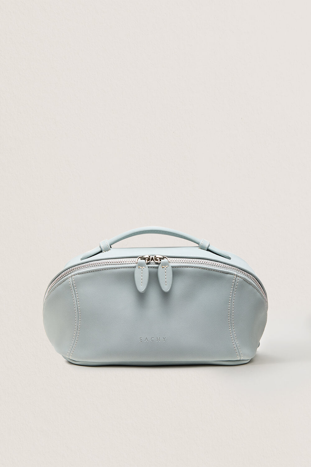Front view of pastel blue large makeup bag for travel, soft cosmetic bag.