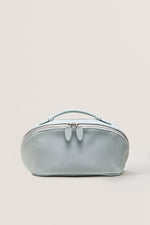 Front view of pastel blue large makeup bag for travel, soft cosmetic bag.