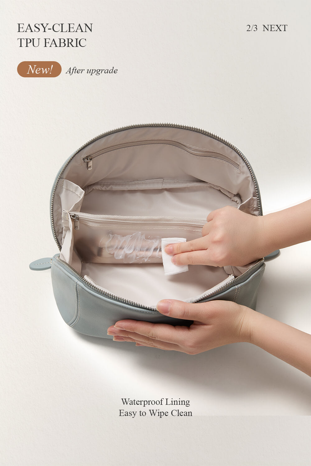 Hands wiping clean the interior of blue makeup bag, waterproof travel toiletry bag.